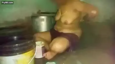 Indian aunty bathing in village home
